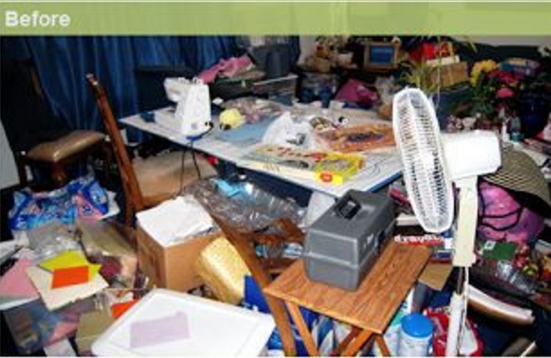 Cluttered living room before cleaning